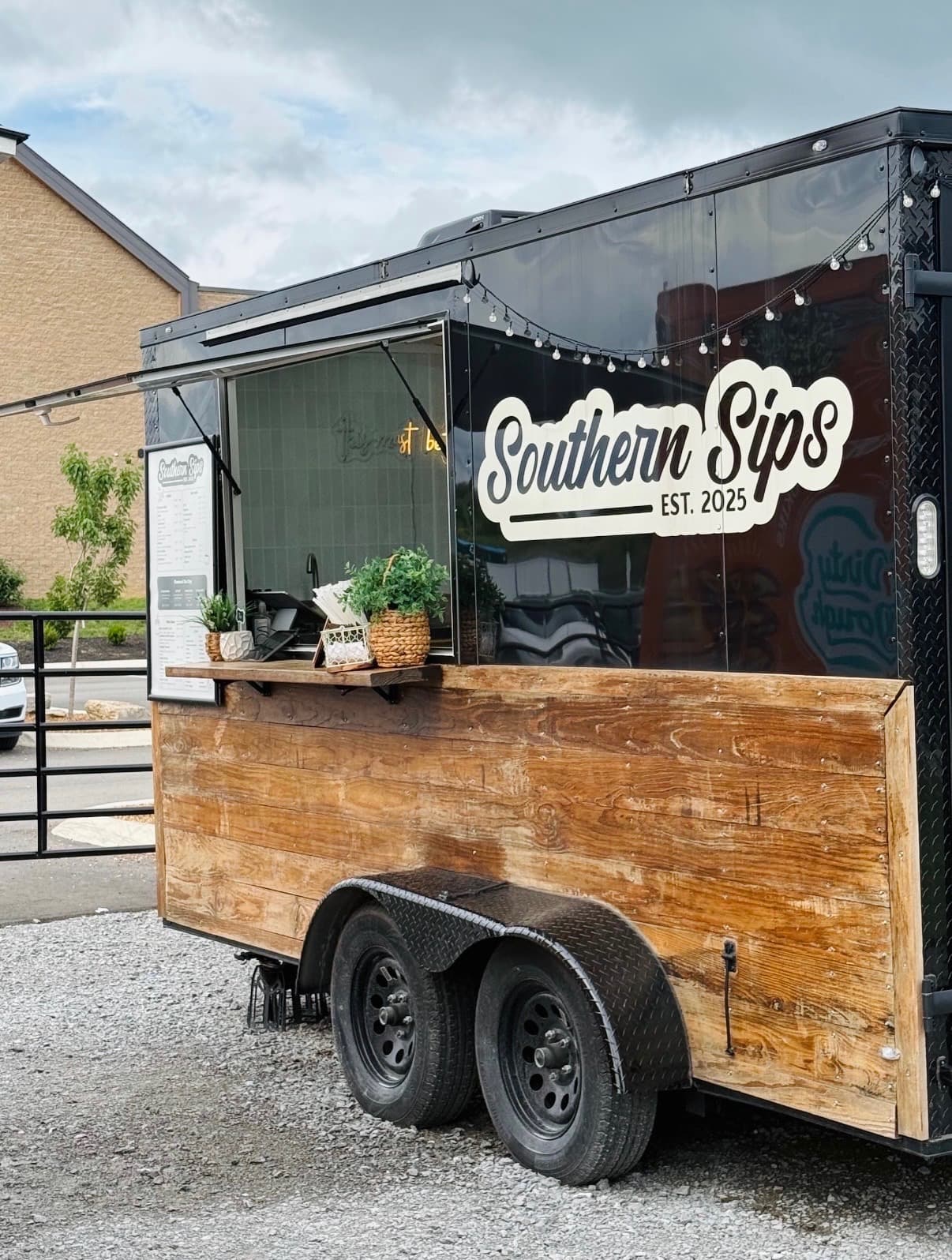 Southern Sips Magnolia trailer with wood siding, serving window, and Southern Sips EST. 2025 logo